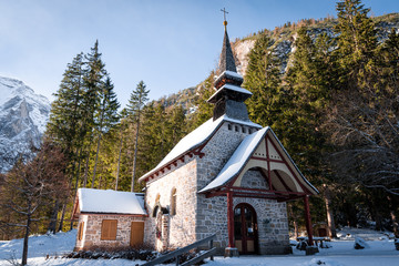 church of braies lake during winter covered by snow located in the Dolomites, South Tyrol Italy