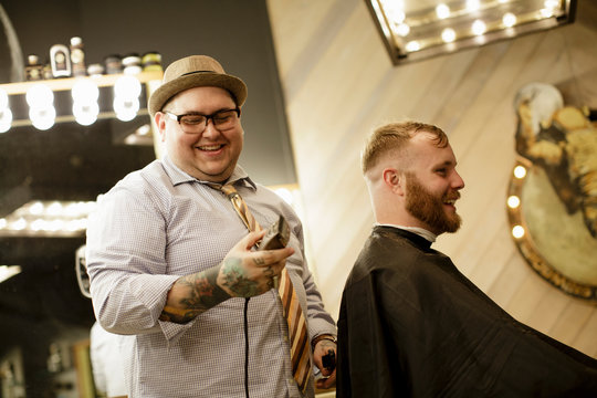 Barber and client laughing