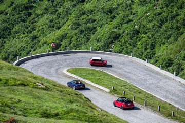 Autos fahren auf einer kurvigen Strasse in den Alpen