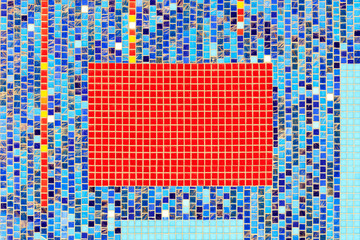 On the wall lined with blue ceramic mosaic the selected fragment is lined with red mosaic.