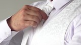closeup of a man adjusting his tie