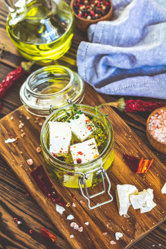 Feta cheese marinated in olive oil in glass jar