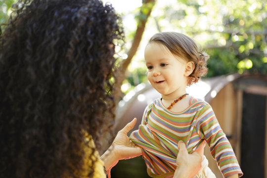 Mother puts shirt on toddler