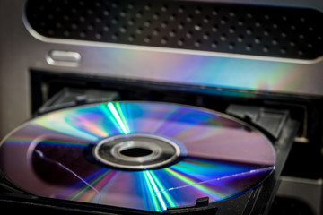 a CD with a scratch. CD in the computer drive.