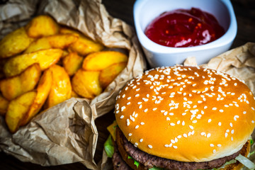 Photo fast food. Hamburger, fried potatoes and tomato sauce.