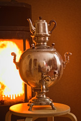Chrome-plated Samovar and tea near the fireplace