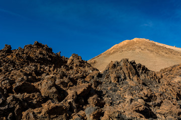 Majestic volcanic cone rising above spectacular lava shaped landscape.