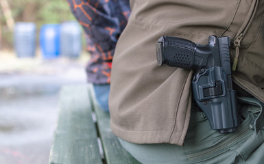 Gun in the holster, civilian in casual clothes.