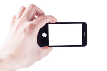 A blank for the designer, the phone takes a photograph in his hand on a white background with a white screen, isolate mobile photography in trend
