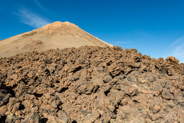 Majestic volcanic cone rising above spectacular lava shaped landscape.