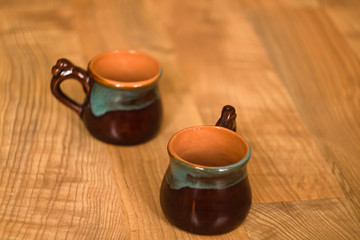 Bruan Ceramic cups on wooden background