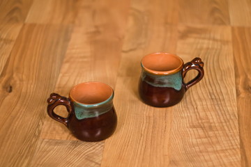 Two Bruan Ceramic cups on wooden