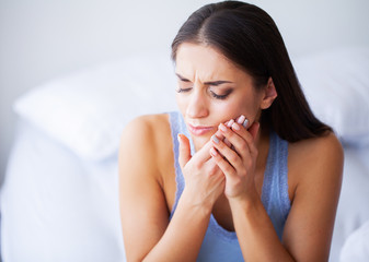 Teeth Problem. Woman Feeling Tooth Pain. Closeup Of A Beautiful Sad Girl Suffering From Strong Tooth Pain. Attractive Female Feeling Painful Toothache. Dental Health And Care Concept