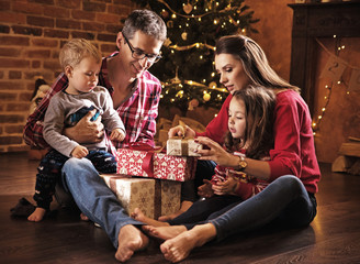 Cheerful family unboxing presents together