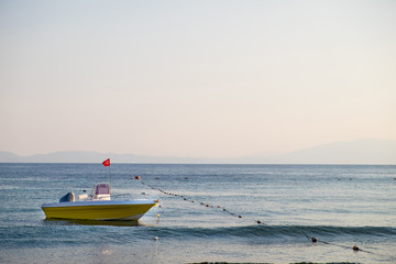 Empty rescue boat with the flag of Turkey to the sea on the background of the rocky coast under the...
