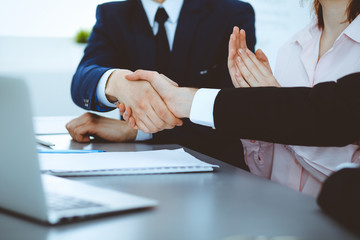 Business people shaking hands finishing up a meeting. Handshake at successful negotiation