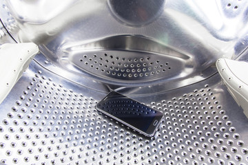 fallen from the pocket of clothes cell phone is inside the washing machine drum