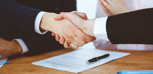 Business people shaking hands finishing up a meeting. Handshake at successful negotiation