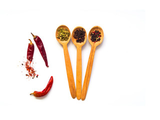 Wooden spoons with spices isolated on white background. 