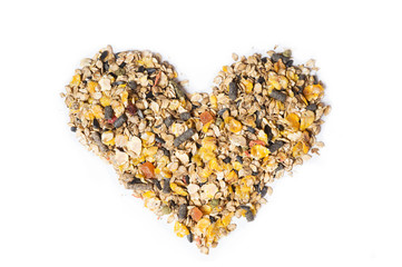 basic muesli  with fruits for horse background  in form of heart. isolated