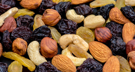 Fruits and nuts. Cashews, almonds, hazelnuts and raisins. Close-up.