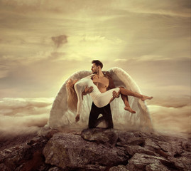 Portrait of an archangel carrying a beautiful innocent woman