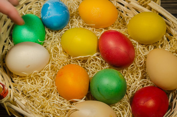 Fototapeta na wymiar colored eggs in wicker basket 