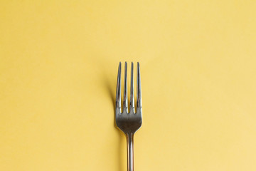 Fork isolated on yellow