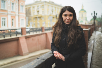 Portrait of a city girl in a black jacket. Girl walking in the fresh air