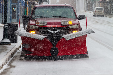 Red Truck with Red Plow on snowy street