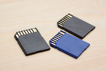 Modern fast SD memory cards on wooden table ready to use in different devices