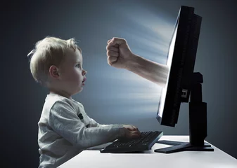 Fototapete Rund Little boy looking at the display  monitor - Internet violence symbol © konradbak