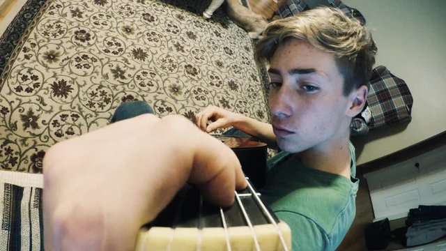 Boy Plays a Classical Guitar