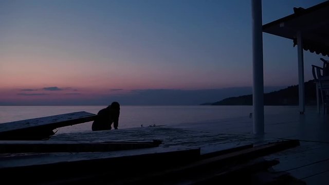 Young Male Traveler making a frontflip at the seaside