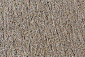 Natural sand texture of the beach. Brands made by water flowing through the sand of the beach.