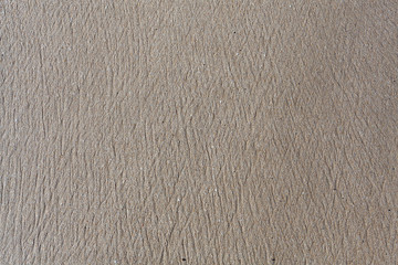 Natural sand texture of the beach. Brands made by water flowing through the sand of the beach.