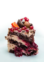 Piece of chocolate cake with berries on white background