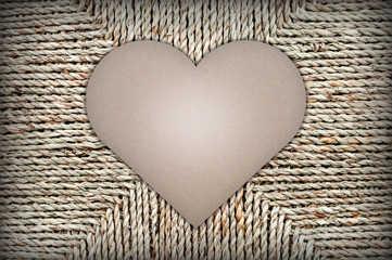 cardboard heart shape on background of wicker basket. space for text