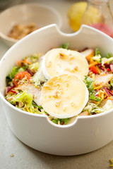 Salad with lettuce, fried pears, camembert, walnuts, red onion, tomatoes and raspberry vinaigrette dressing