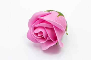 Bright pink rose flower made from soap close-up isolated on white background