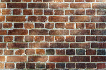 Obraz premium the old walls of red brick, lit by spots of light. background.