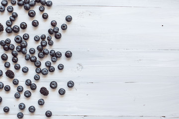 Blueberry and blackberry on a wooden table top view.