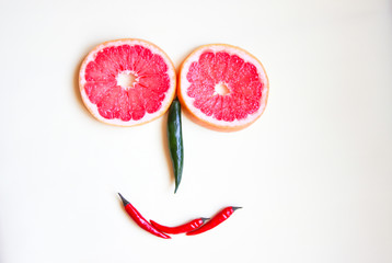 funny face made of fruit and colored hot pepper