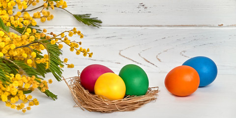 Colorful easter eggs with flowers on white wooden background Happy Easter concept