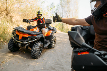 Fototapeta na wymiar ATV rider showing thumbs up to his partner 