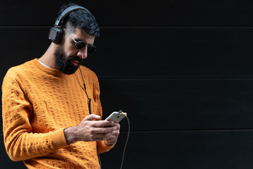 Hipster Man Listening Music on Headphones.