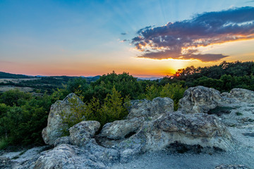 The sun setting over the Stone Mushrooms near Beli Plast village, Kardzhali Municipality, Bulgaria - obrazy, fototapety, plakaty
