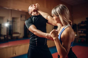 Fotobehang Female person on self-defense workout with trainer © Nomad_Soul
