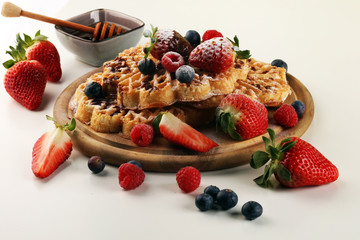 Waffle. Traditional belgian waffles with fresh fruit and powder sugar on wood