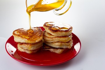 Honey syrup on pancake, delicious dessert food on white,  sweet.